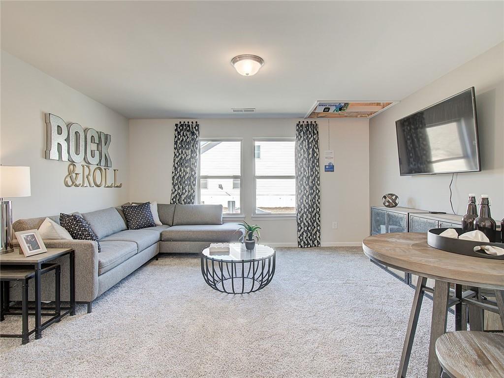 486 Tallulah Lane Grayson, GA 30017 - Photo 14 of 17 a living room with furniture and a flat screen tv