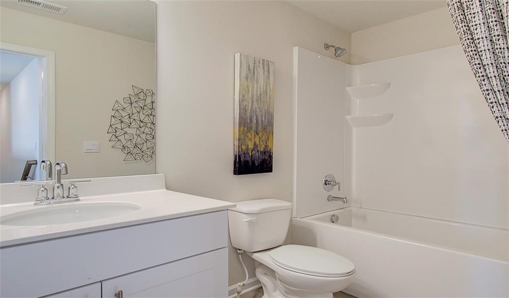 486 Tallulah Lane Grayson, GA 30017 - Photo 16 of 17 a bathroom with a sink a toilet and shower