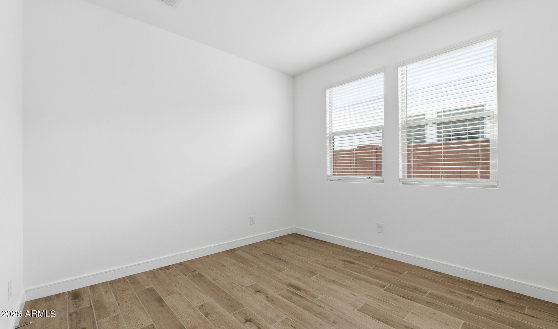 8010 West Royal Palm Road Peoria, AZ 85345 - Photo 9 of 34 an empty room with wooden floor and windows