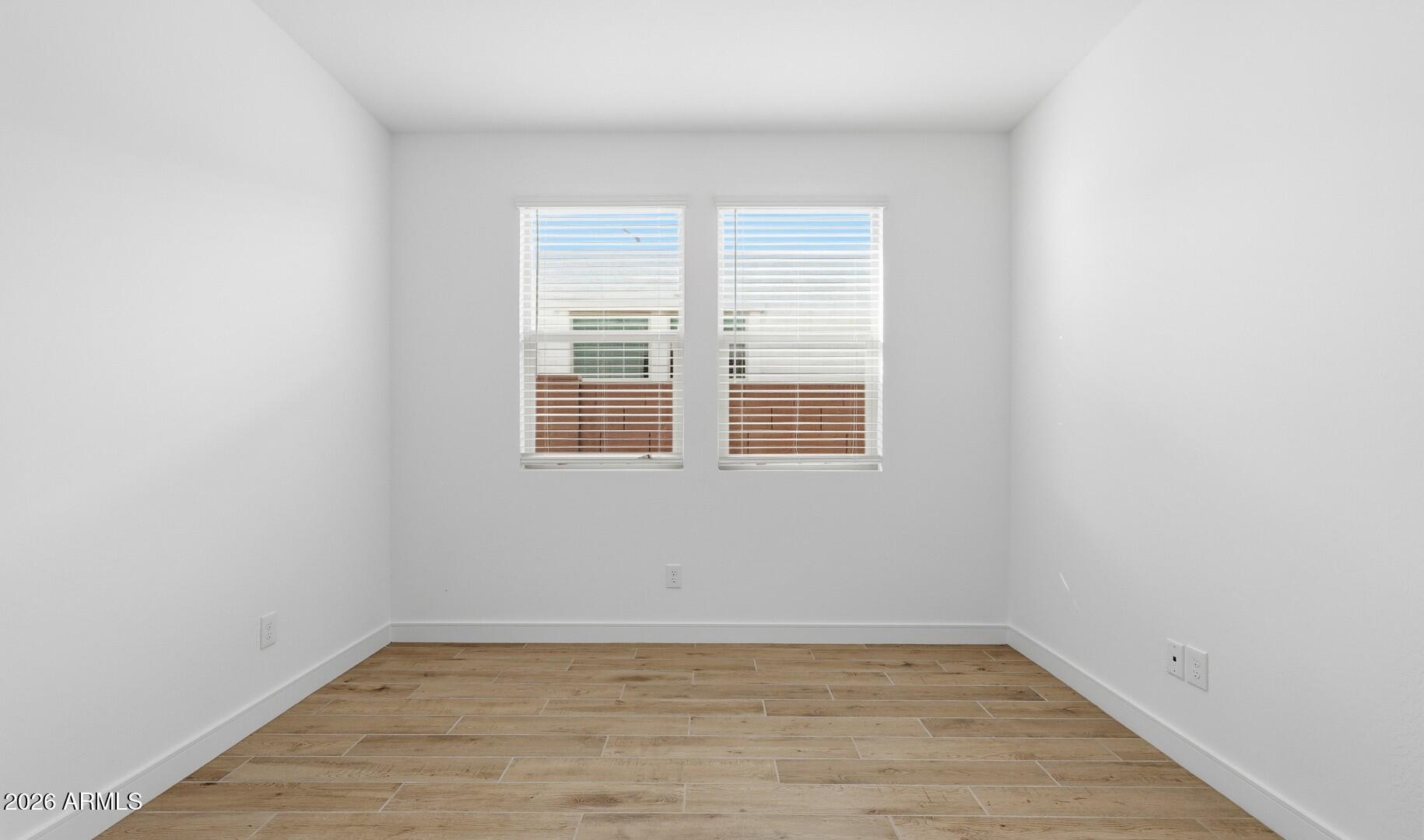 8010 West Royal Palm Road Peoria, AZ 85345 - Photo 10 of 34 a view of empty room with wooden floor and fan