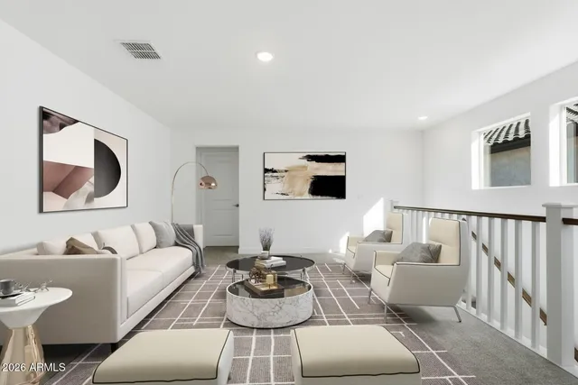 a living room with furniture and a lamp