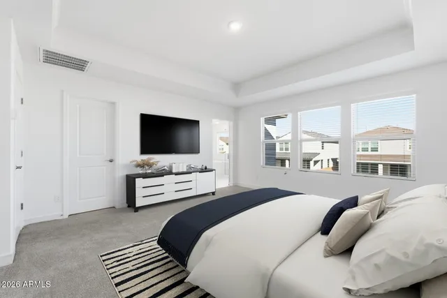 a spacious bathroom with double sink a mirror a window and a bathtub