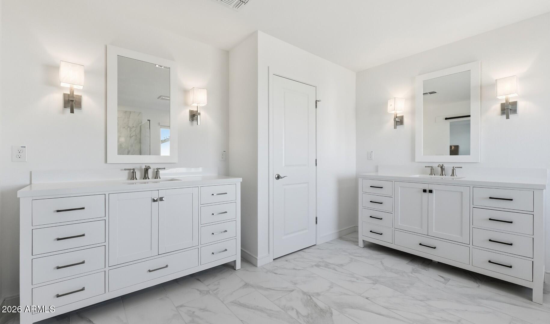 8010 West Royal Palm Road Peoria, AZ 85345 - Photo 26 of 34 a spacious bathroom with double sink a mirror a window and a bathtub