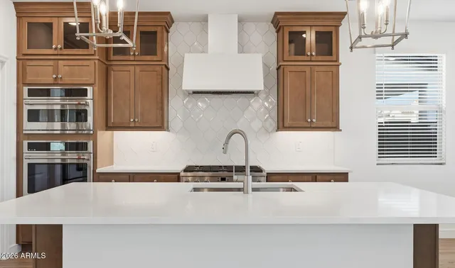a kitchen with a sink dishwasher a stove and a refrigerator with wooden floor