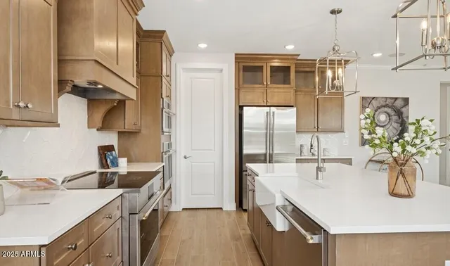 a kitchen with kitchen island a counter top space appliances and cabinets