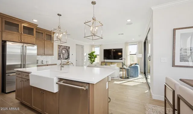 a kitchen with stainless steel appliances granite countertop a sink a stove and a wooden floors