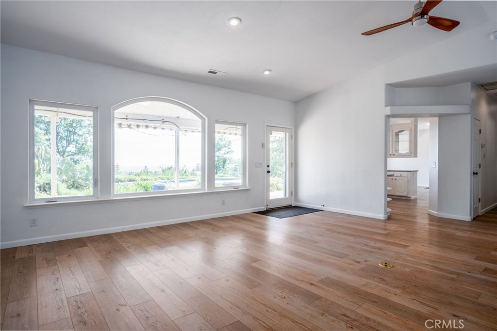 4620 Wendlis Road Forest Ranch, CA 95942 - Photo 14 of 50 an empty room with wooden floor and windows