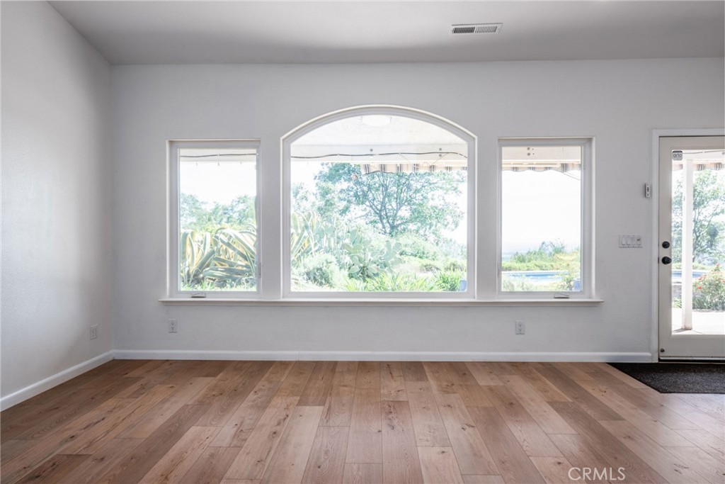4620 Wendlis Road Forest Ranch, CA 95942 - Photo 17 of 50 an empty room with wooden floor and windows