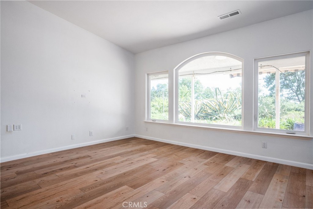 4620 Wendlis Road Forest Ranch, CA 95942 - Photo 18 of 50 an empty room with wooden floor and windows