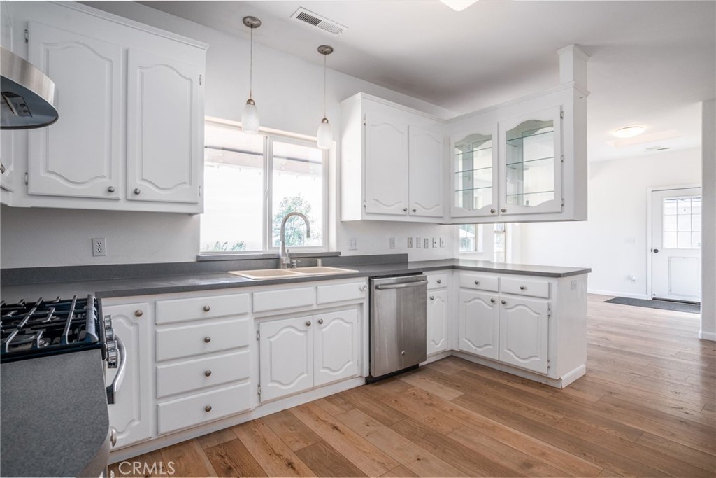 4620 Wendlis Road Forest Ranch, CA 95942 - Photo 19 of 50 a kitchen with granite countertop white cabinets and white appliances