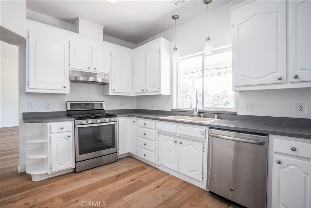 4620 Wendlis Road Forest Ranch, CA 95942 - Photo 20 of 50 a kitchen with granite countertop white cabinets and white appliances