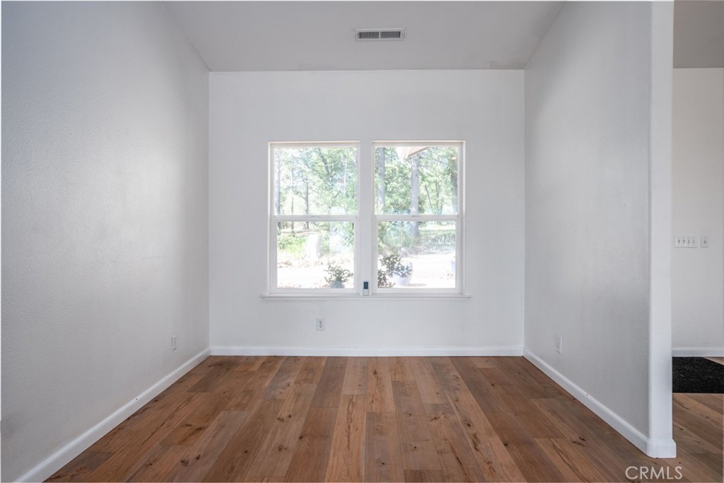 4620 Wendlis Road Forest Ranch, CA 95942 - Photo 26 of 50 an empty room with wooden floor and windows