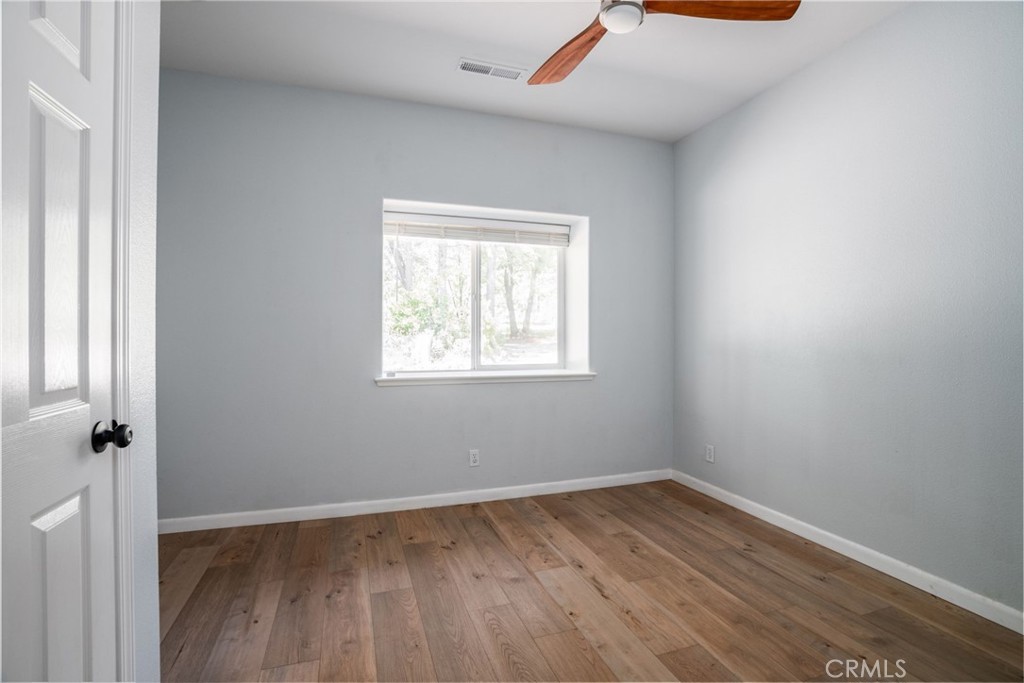 4620 Wendlis Road Forest Ranch, CA 95942 - Photo 33 of 50 an empty room with wooden floor and windows