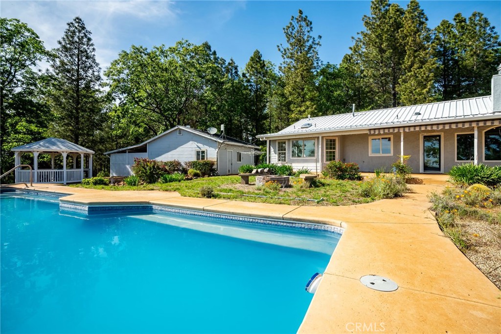4620 Wendlis Road Forest Ranch, CA 95942 - Photo 34 of 50 a house with swimming pool in front of it