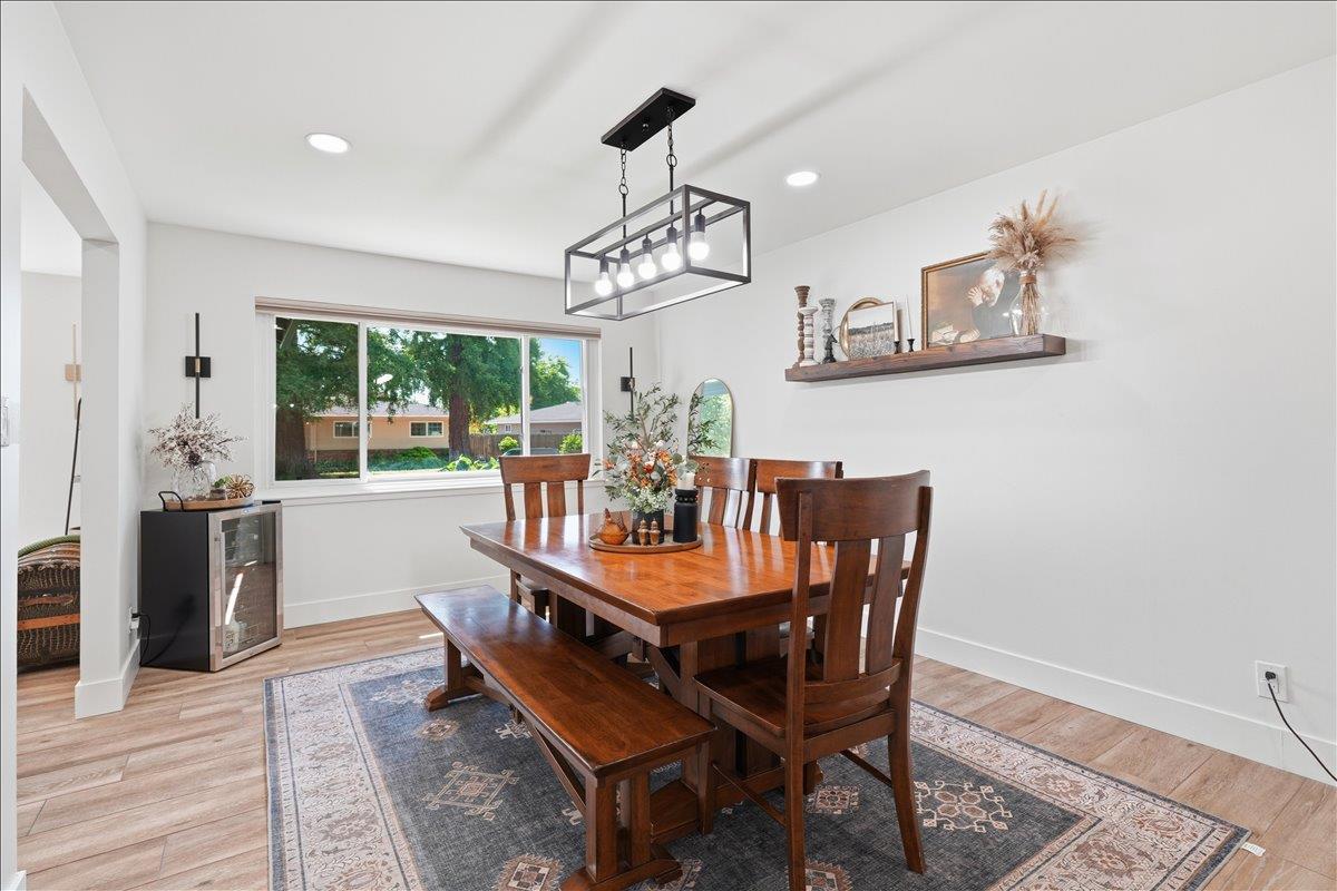 4849 Alexon Way Carmichael, CA 95608 - Photo 22 of 50 a dining room with furniture a chandelier and wooden floor