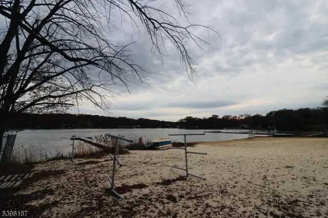 a group of chairs sitting in a roof deck under a large umbrella