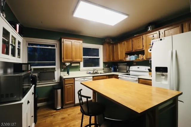 a kitchen with a refrigerator a stove a sink and a microwave