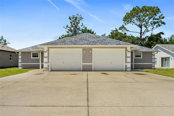 a front view of a house with a garage