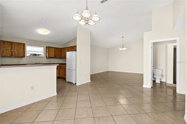 a view of a kitchen with a sink and a refrigerator