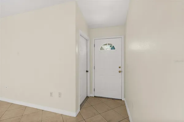 a view of an empty room with a kitchen