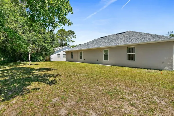 a front view of a house with a garden and yard