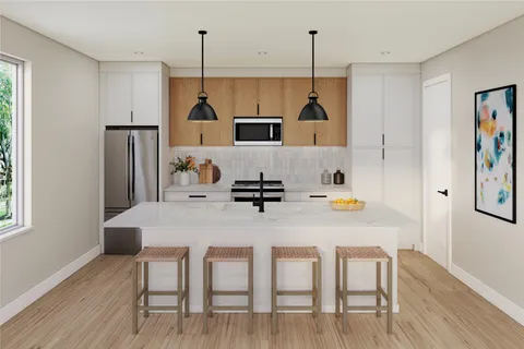 a kitchen with refrigerator cabinets and wooden floor