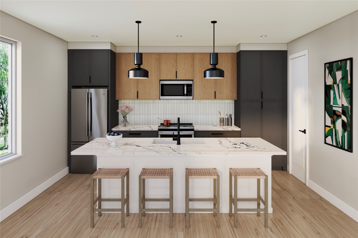 1200 Bianca Breeze Place Austin, TX 78721 - Photo 20 of 32 a kitchen with refrigerator cabinets and wooden floor