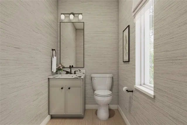 a bathroom with a toilet a sink a mirror a shower a vanity and window