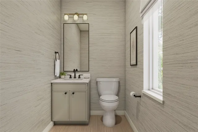 a bathroom with a granite countertop sink a toilet and shower