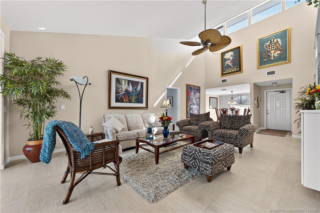 a living room with furniture and a potted plant