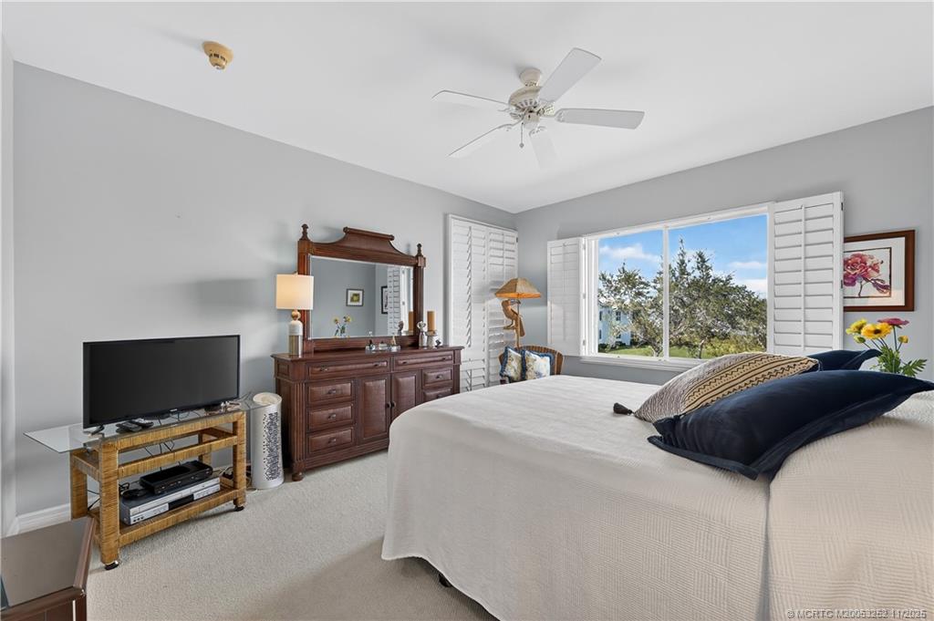 12392 Harbour Ridge Boulevard, Unit 54 Palm City, FL 34990 - Photo 16 of 35 a bedroom with a bed and a flat screen tv