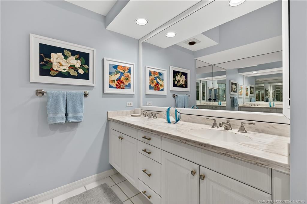 12392 Harbour Ridge Boulevard, Unit 54 Palm City, FL 34990 - Photo 18 of 35 a bathroom with a sink double vanity and window