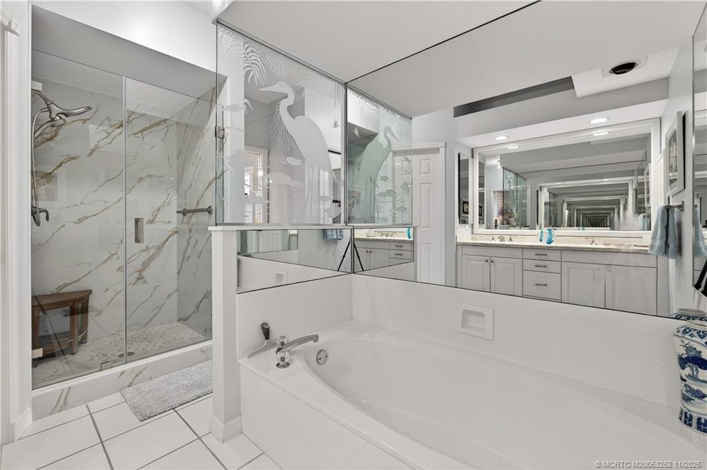 12392 Harbour Ridge Boulevard, Unit 54 Palm City, FL 34990 - Photo 19 of 35 a bathroom with a bathtub and a shower