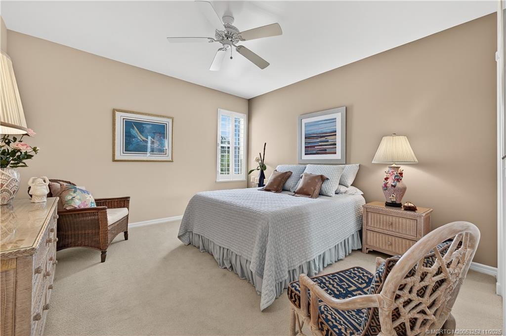12392 Harbour Ridge Boulevard, Unit 54 Palm City, FL 34990 - Photo 20 of 35 a bedroom with a bed and a chandelier