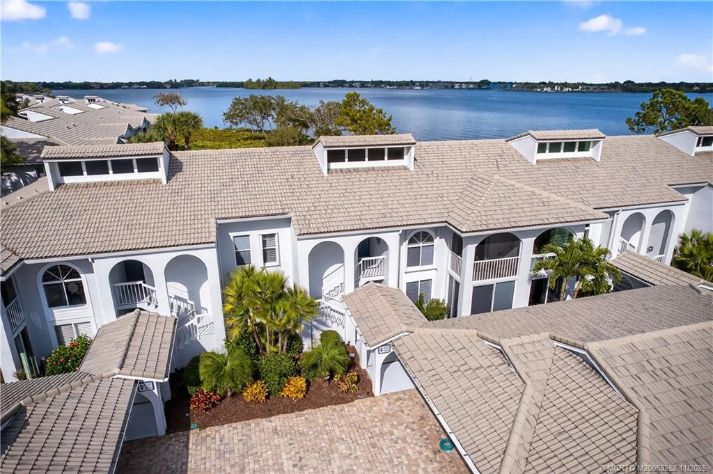 12392 Harbour Ridge Boulevard, Unit 54 Palm City, FL 34990 - Photo 2 of 35 a front view of a house with a yard