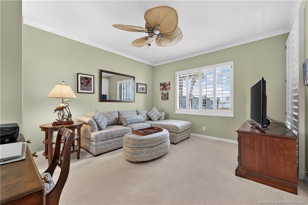12392 Harbour Ridge Boulevard, Unit 54 Palm City, FL 34990 - Photo 21 of 35 a living room with furniture a flat screen tv and a window