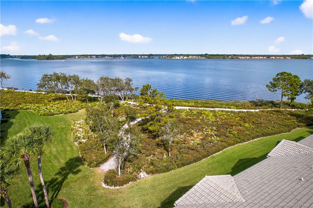 12392 Harbour Ridge Boulevard, Unit 54 Palm City, FL 34990 - Photo 27 of 35 a view of a lake with a garden