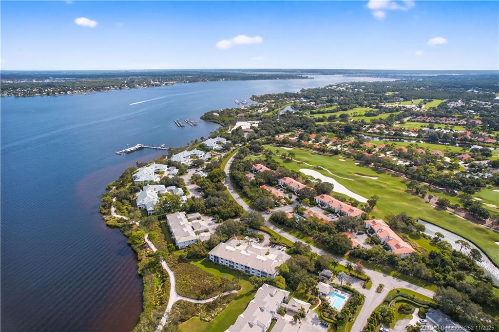 12392 Harbour Ridge Boulevard, Unit 54 Palm City, FL 34990 - Photo 29 of 35 an aerial view of a golf course with an ocean