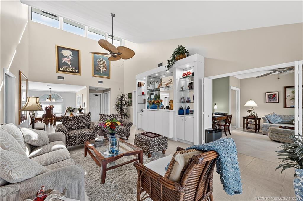12392 Harbour Ridge Boulevard, Unit 54 Palm City, FL 34990 - Photo 7 of 35 a living room with furniture a rug and wall paintings