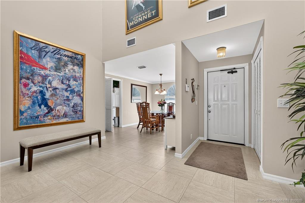 12392 Harbour Ridge Boulevard, Unit 54 Palm City, FL 34990 - Photo 8 of 35 a view of a livingroom with furniture and a painting on the wall