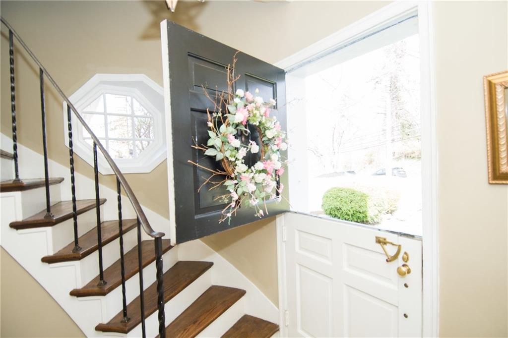 4917 Baptist Road Whitehall, PA 15227 - Photo 2 of 25 Upon entering you will see it is not just your average cape cod style home. Most notable to the entry is the Dutch entry door, curving, wood staircase with wrought iron railing and porthole style window.