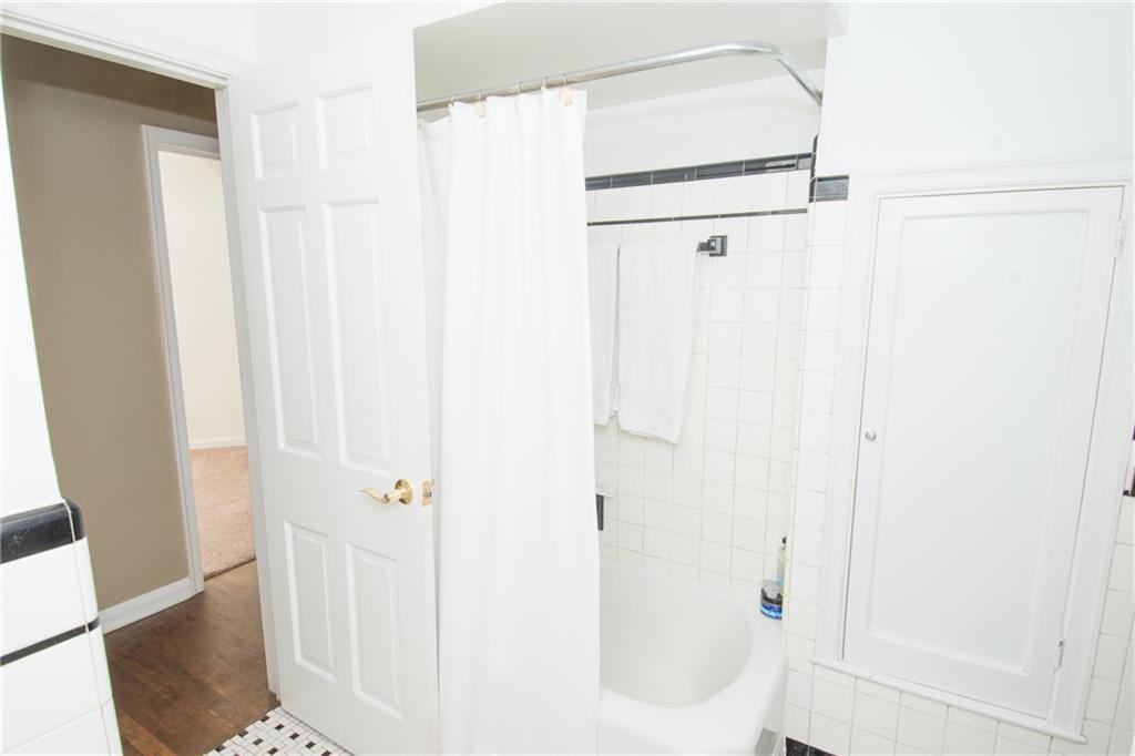 4917 Baptist Road Whitehall, PA 15227 - Photo 13 of 25 A view of the combination tub and shower. The plumbing and fixtures have been updated. Take note of the built in cabinet located in this room for convenient storage.