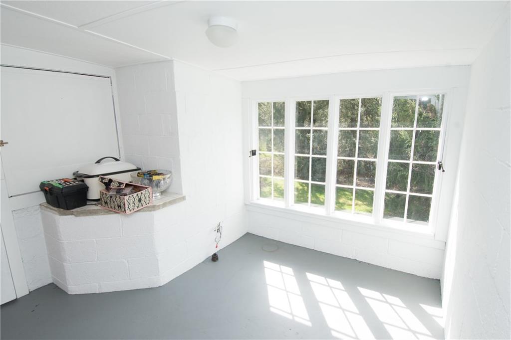 4917 Baptist Road Whitehall, PA 15227 - Photo 19 of 25 This is the extra room off of the screened in porch. Note the levered door/window to the left. This opens to create a more open space into the porch area. The possible uses for this space are limitless! Office, craft room, work out room...