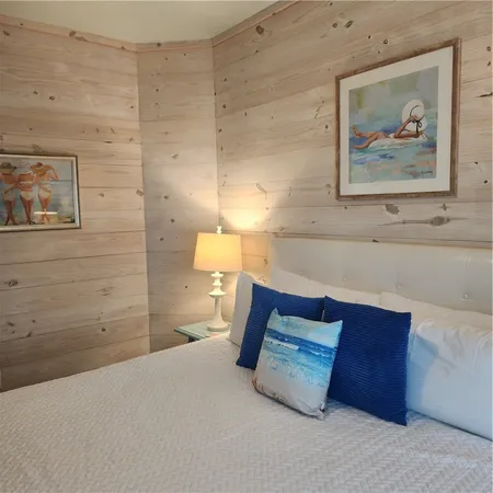 a bedroom with a bed and wall painting