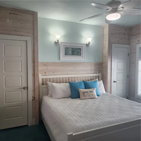 a bedroom with a bed and a mirror