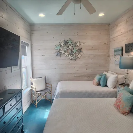 a bed room with a bed and a chair