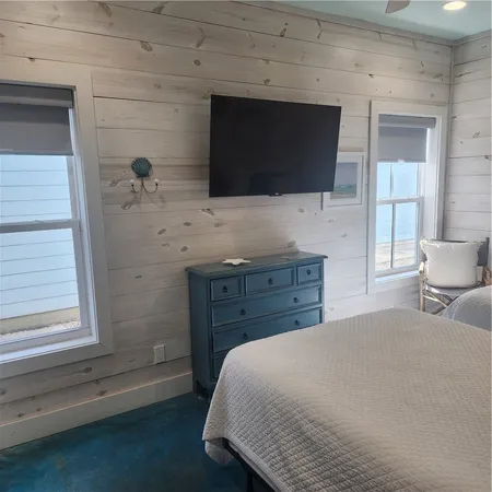 a bedroom with a bed and a flat screen tv
