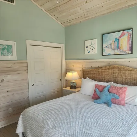 a bedroom with a bed and lamp