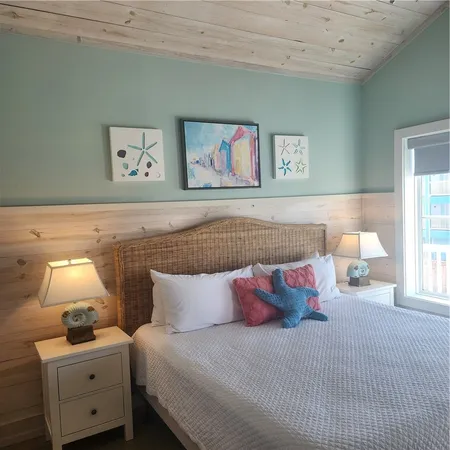 a bedroom with bed and lamp