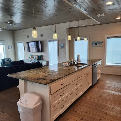 a bathroom with a granite countertop sink and a large mirror